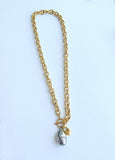 Designer Adrian Hailwood Gold chain necklace with a pendant on a white background